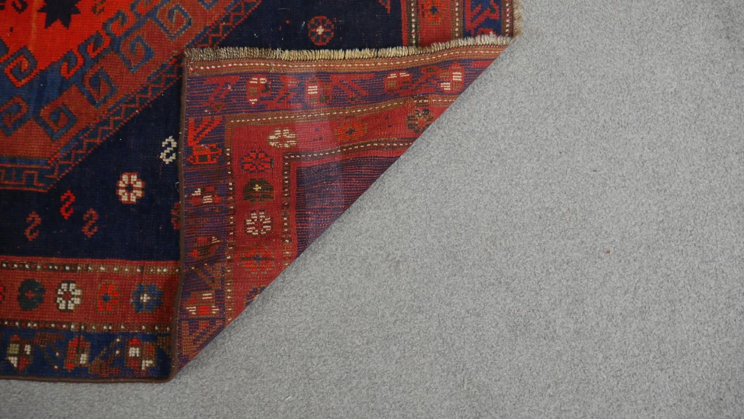 A Shirvan rug with double pole medallions on a navy blue ground within flowerhead borders. L.190 W. - Image 4 of 4