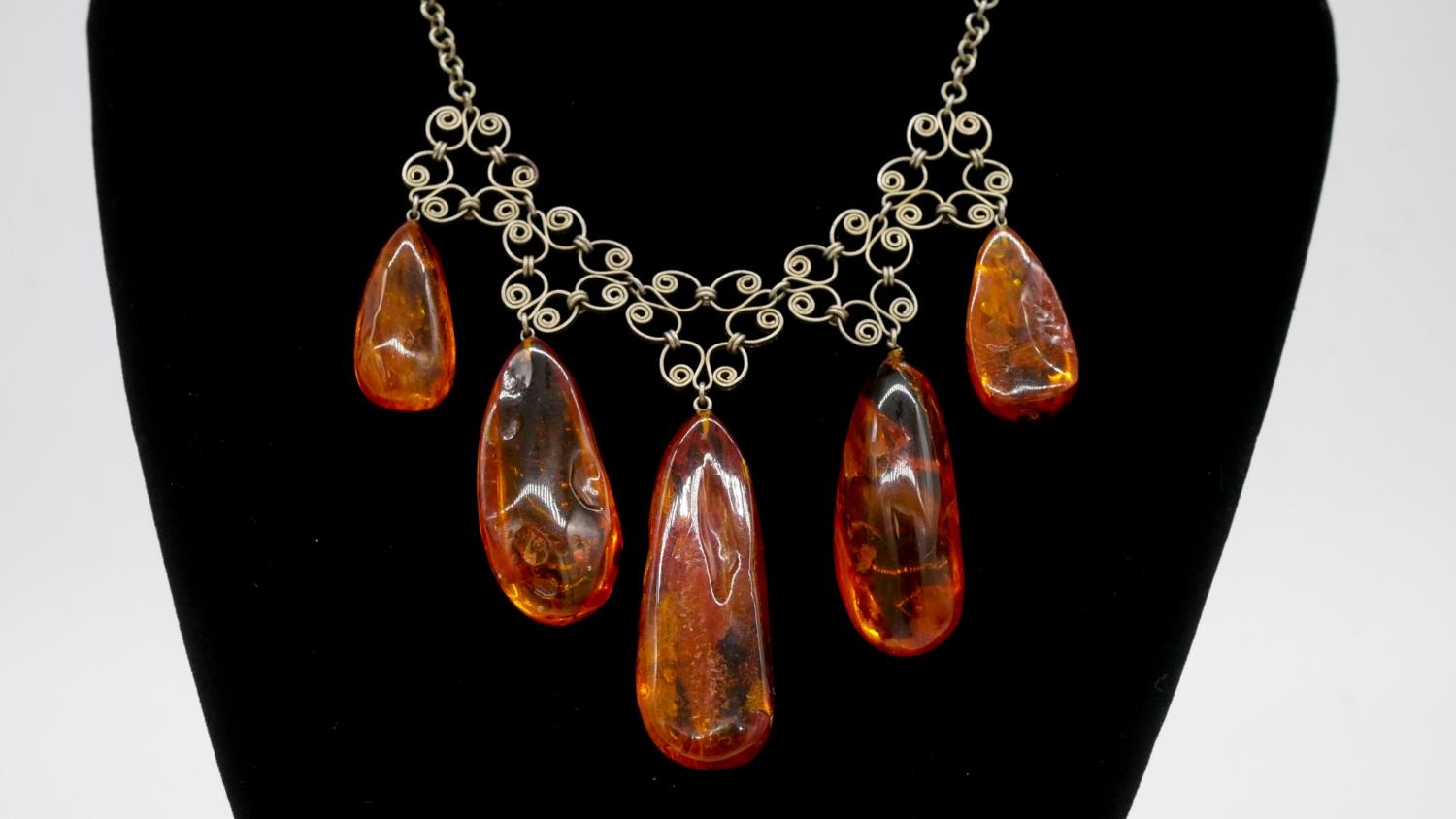 An amber bead elasticated bracelet along with a graduated amber drop necklace with scrolling - Image 3 of 6