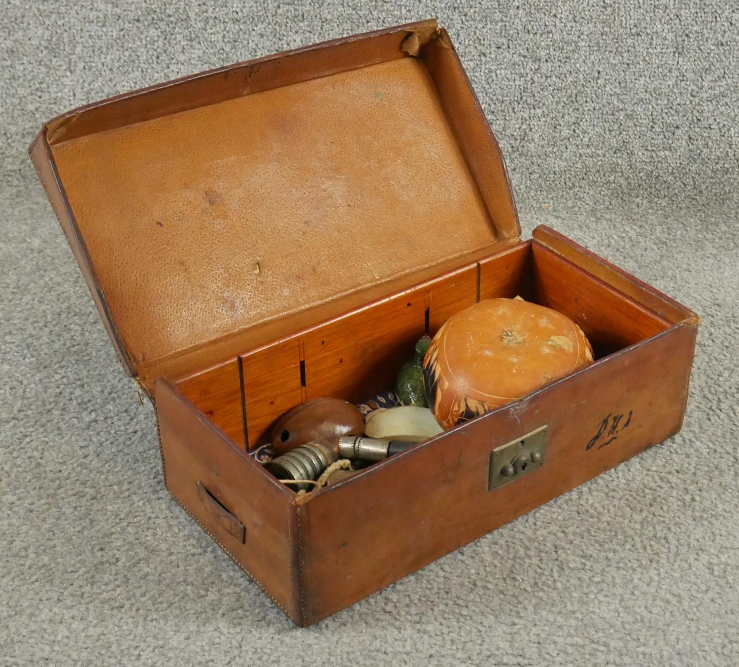 Two antique tan leather suitcases with brass fittings. One filled with curiosities from around the - Image 5 of 6