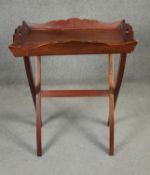 An Eastern teak twin handled butler's tray on stand. H.80cm
