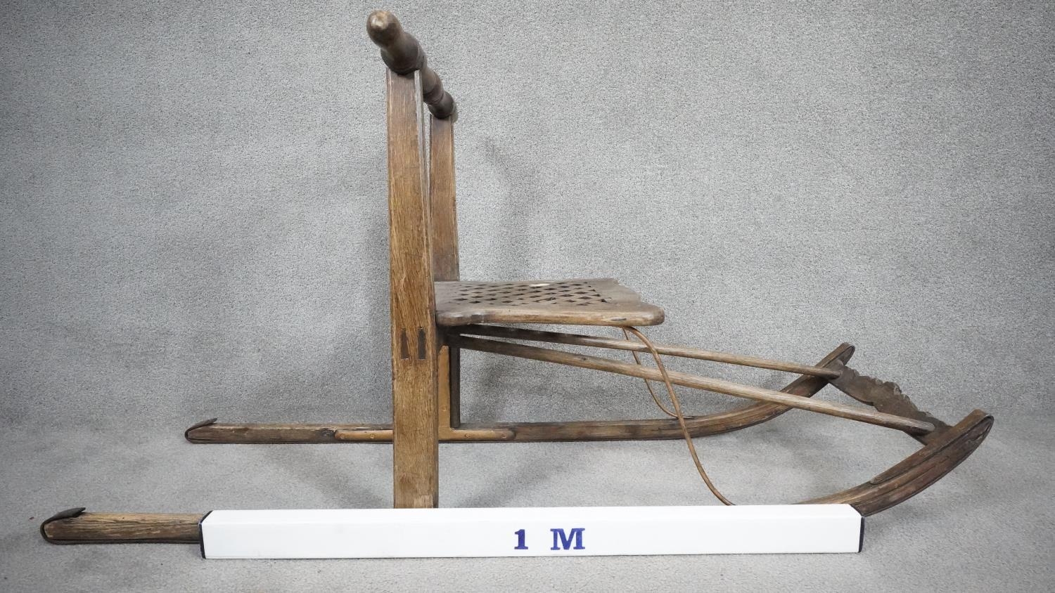 A vintage teak sled with slatted seat on metal faced runners. H.68 L.152cm - Image 4 of 4