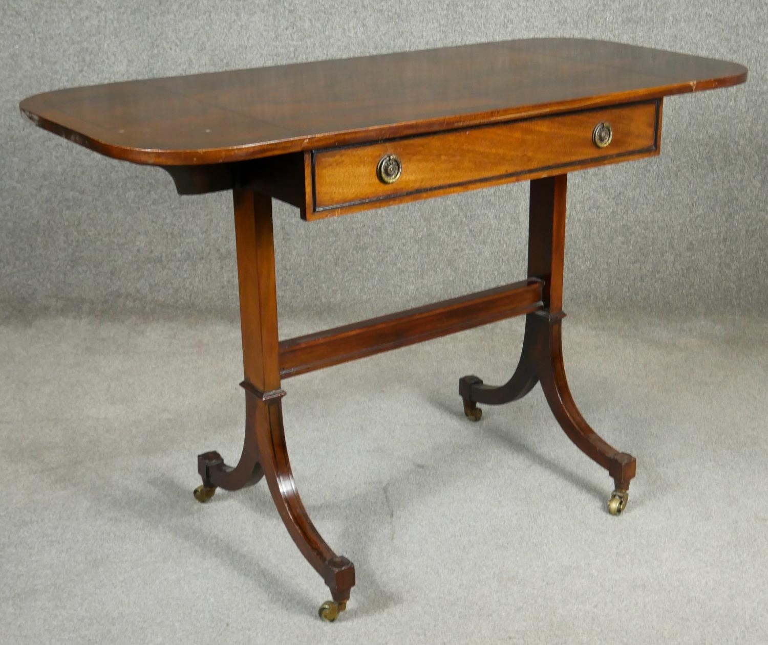 A Regency style flame mahogany and crossbanded sofa table on ebony strung swept supports resting - Image 3 of 7