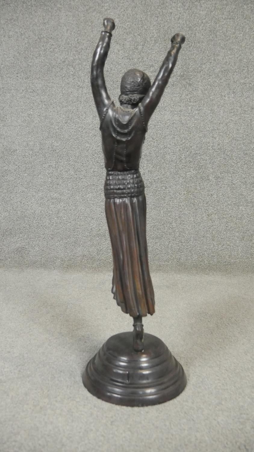An Art Deco style spelter sculpture of a female dancer in period clothing with headdress, on a - Image 2 of 5