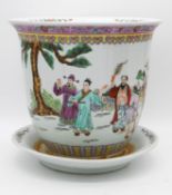 An early 20th century Chinese Famille Rose hand painted porcelain jardinere with dish. Decorated