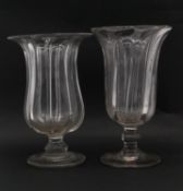 Two 19th century blown clear glass ribbed celery vases. Each with a flared rim and rounded foot with
