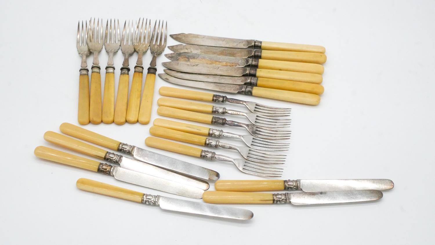 Two sets of twelve person silver plated cutlery. One set of fish knives and forks wuth engraved