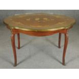 An Italian walnut and floral inlaid occasional table with shaped glass top on ormolu mounted