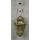 A pierced brass hanging lantern of North African influence. D.25cm