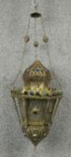 A pierced brass hanging lantern of North African influence. D.25cm