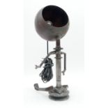 An industrial table lamp in the form of a seated figure with shade for the head. H.45cm