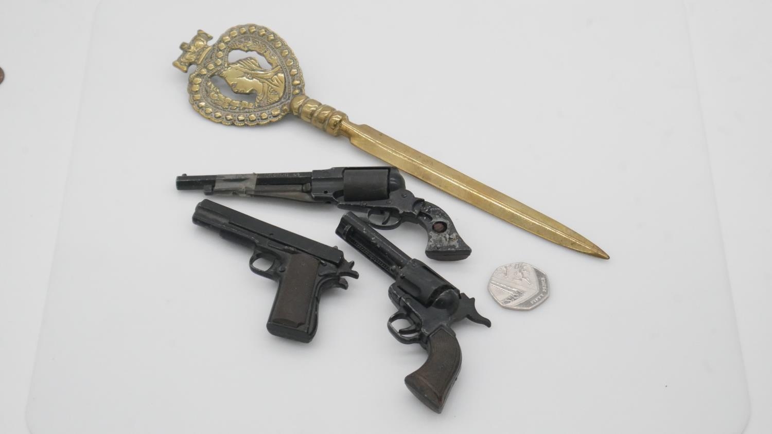 Three Mam Uniwerk, Italy, miniature toy replica cast metal guns and a brass Victorian letter opener. - Image 2 of 10