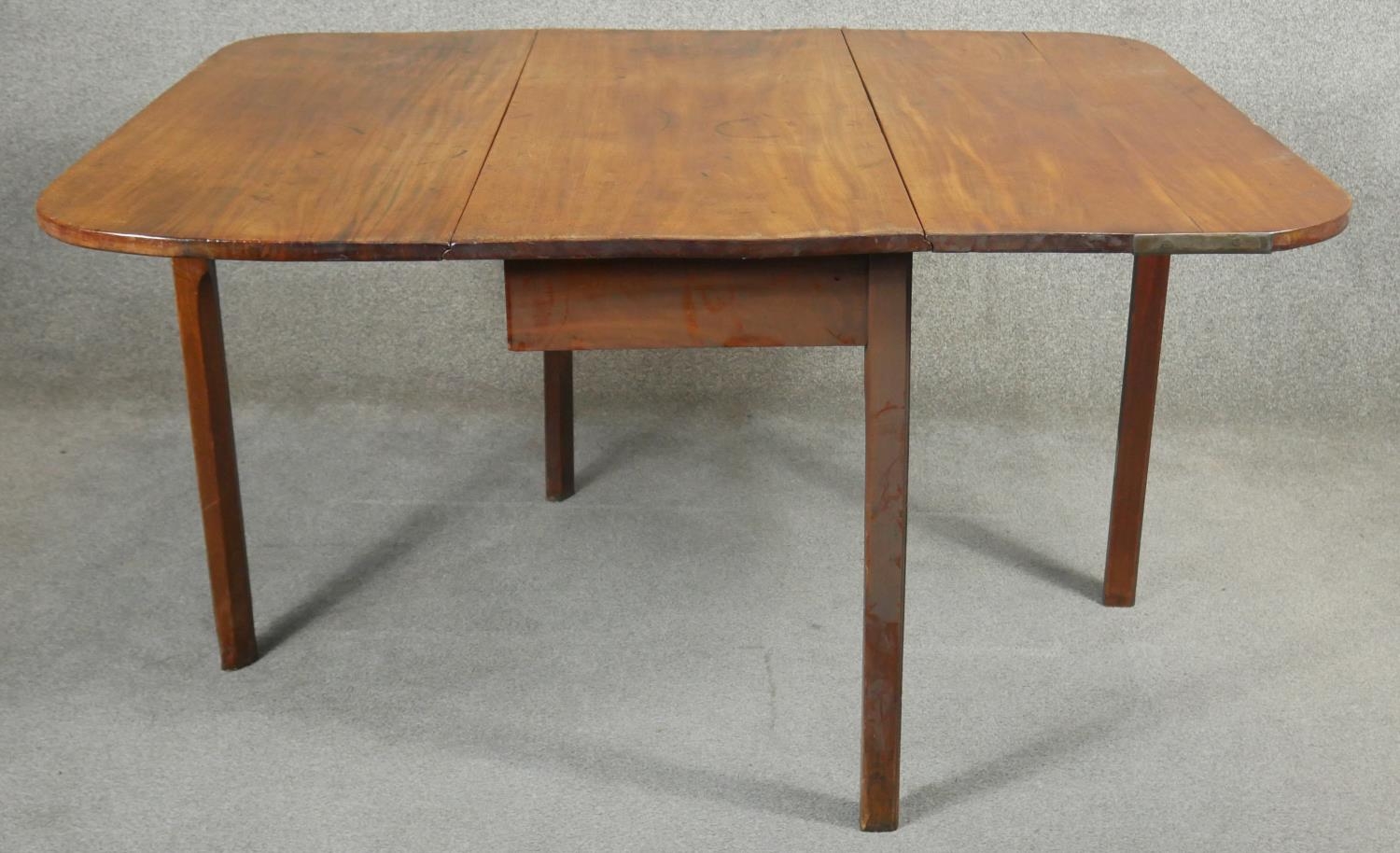 A Georgian mahogany drop flap dining table with gate leg action on square section supports. H.72 L. - Image 3 of 6
