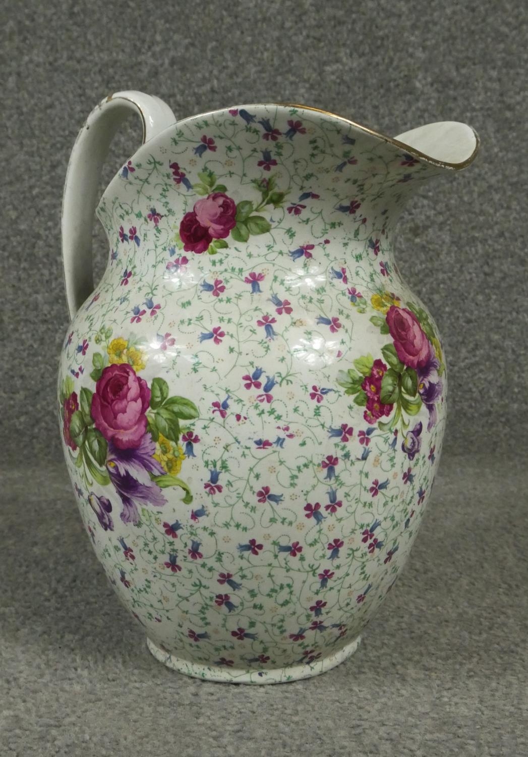 Two Victorian ceramic wash jugs. One with a fuscia ground and decorated with waterlillys and - Image 4 of 6