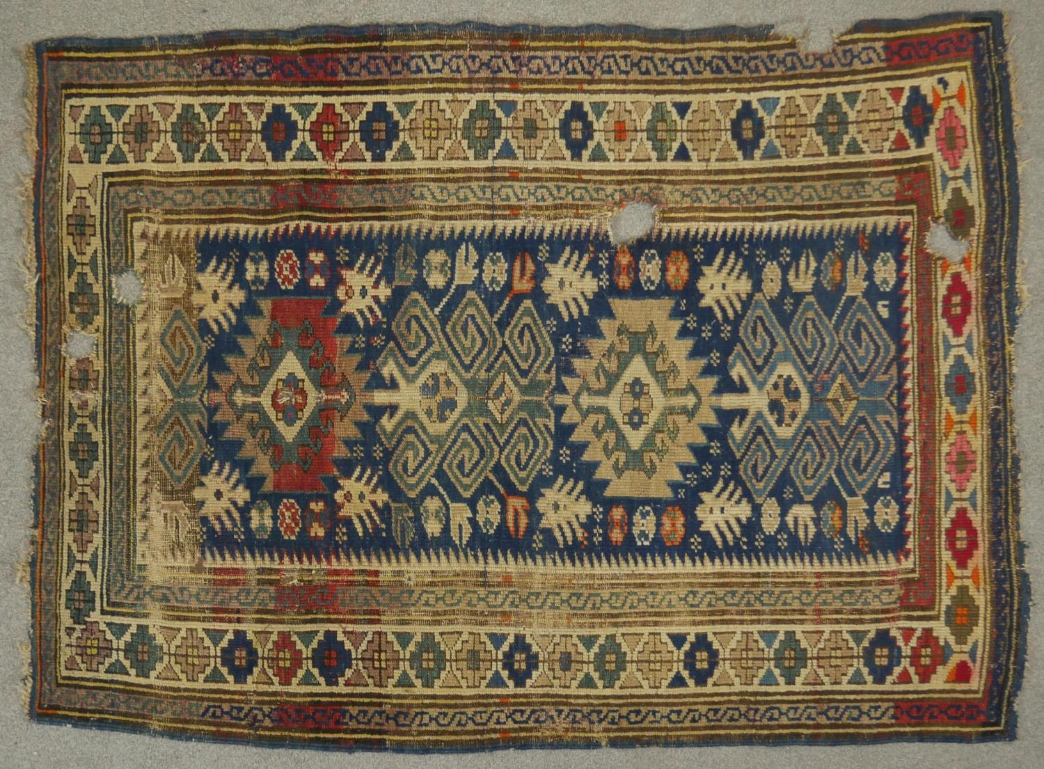 A Kazak rug with central pole medallions in stylised multiple borders. L.151 W.105
