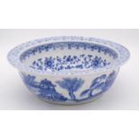 A blue and white Chinese porcelain glazed bowl with stylised floral and foliate design. D.34cm