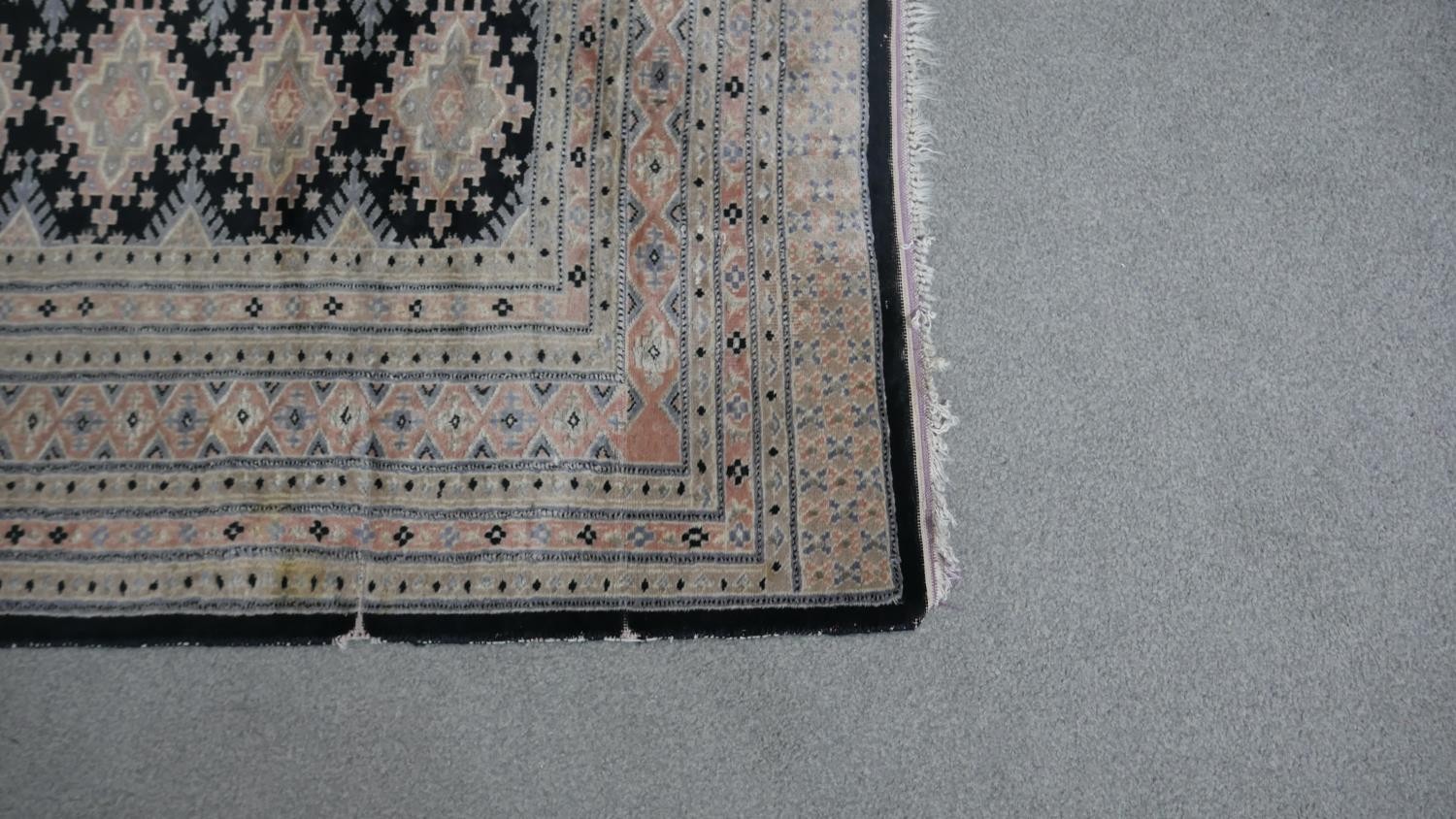 A part silk Bokhara rug with repeating medallions on a midnight ground. L.182 W.128cm - Image 3 of 4