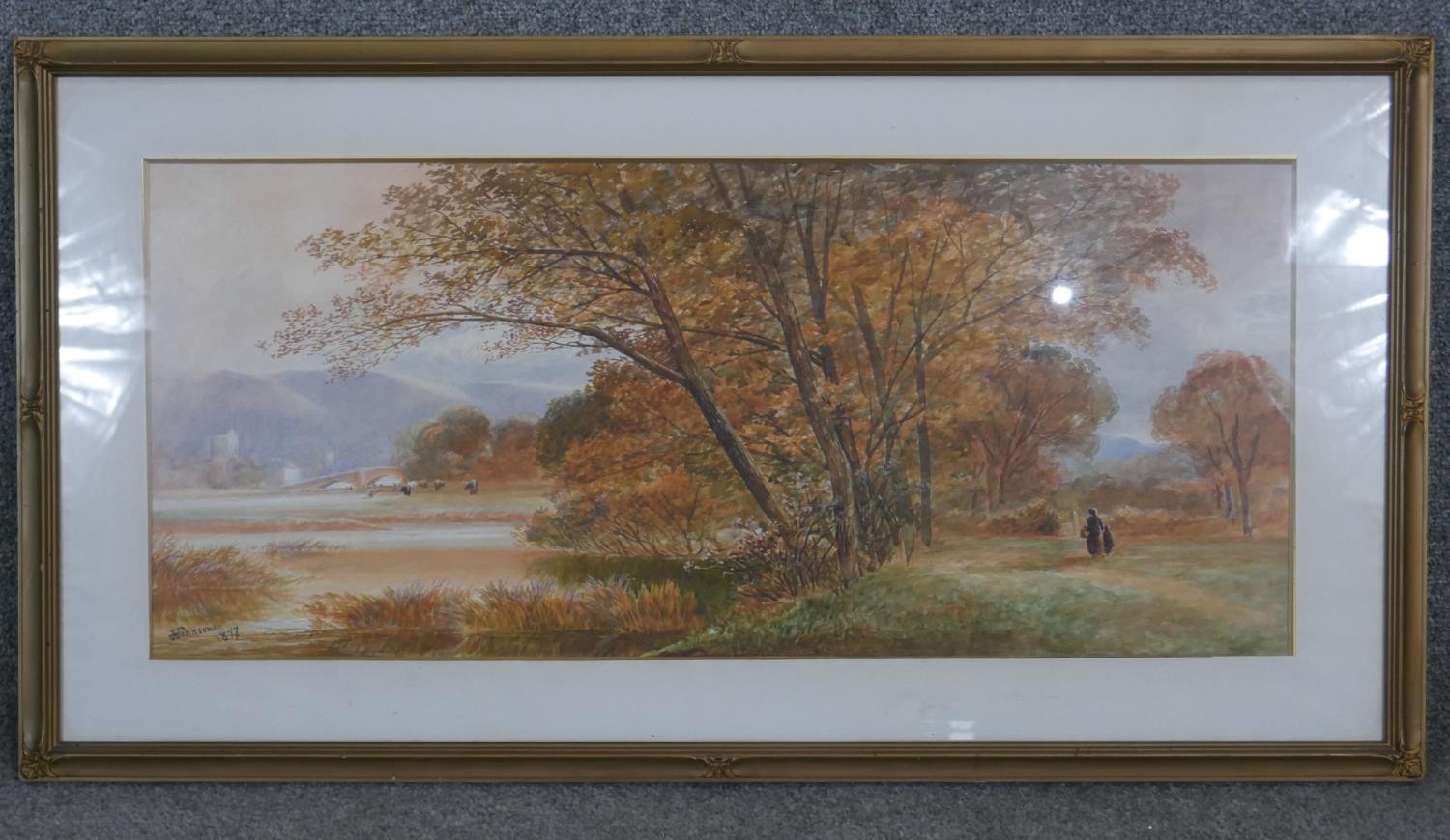 A framed and glazed watercolour landscape of autumn trees. Signed J. Johnson. H50 W93