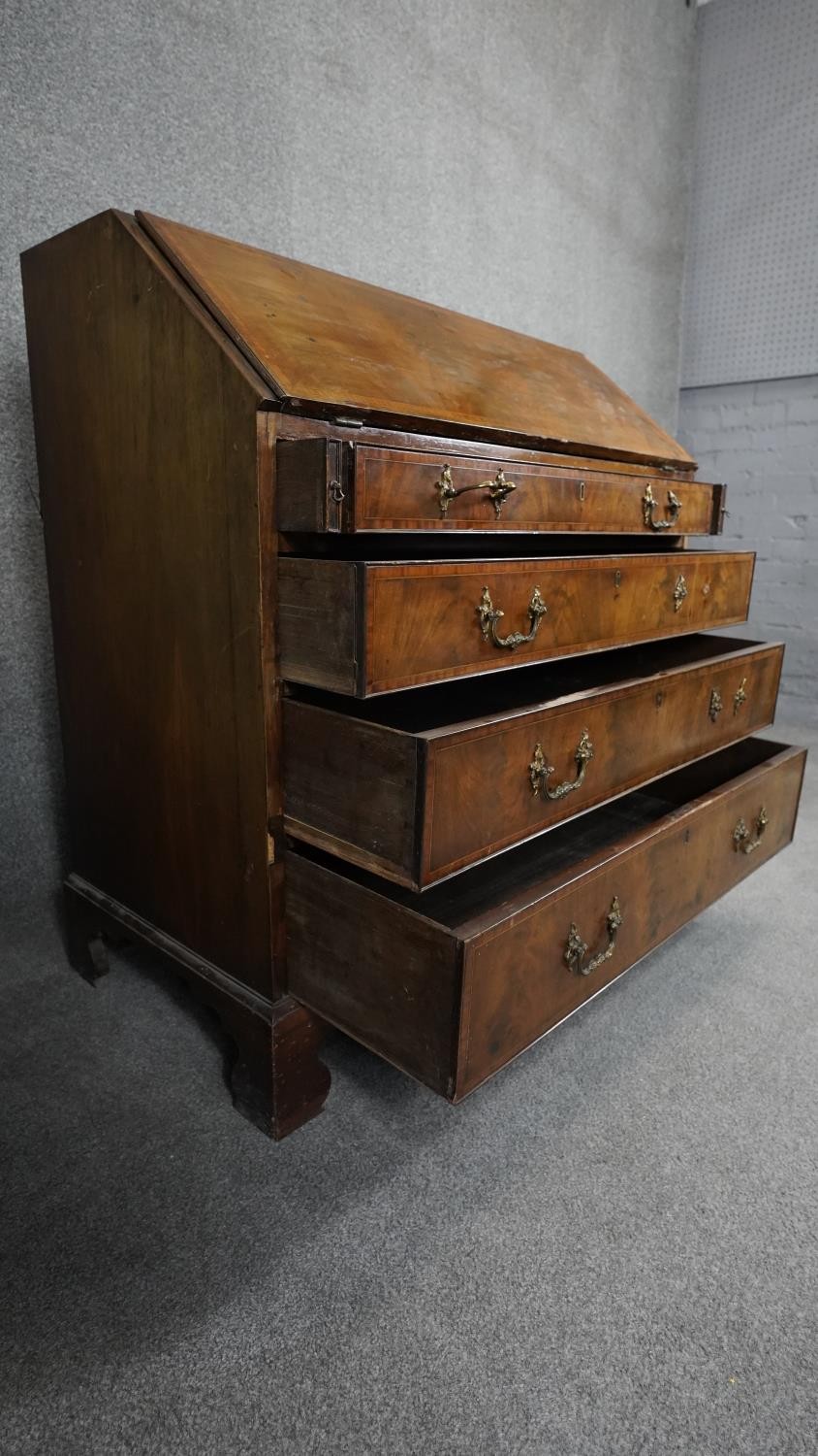 A Georgian flame mahogany and crossbanded bureau with fitted interior on shaped bracket feet. H. - Image 3 of 9