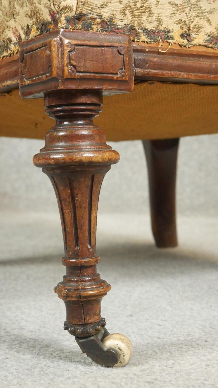 A Victorian walnut nursing chair with floral carved back rail and buttoned upholstery on tapering - Image 4 of 5