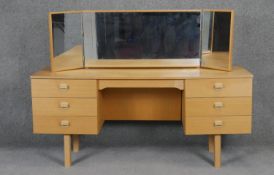 A vintage teak dressing table with adjustable triple vanity mirrors. H66 W150 D44