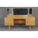 A vintage teak dressing table with adjustable triple vanity mirrors. H66 W150 D44