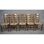A set of five antique style country ladder back dining chairs with rush seats on stretchered