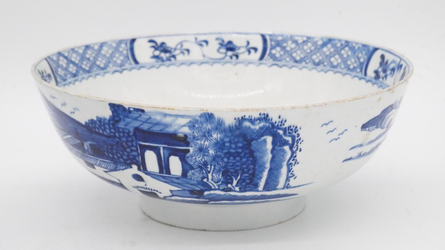 An 18th century blue and white porcelain bowl with unglazed foot and painted Oriental scene. Along - Image 2 of 5