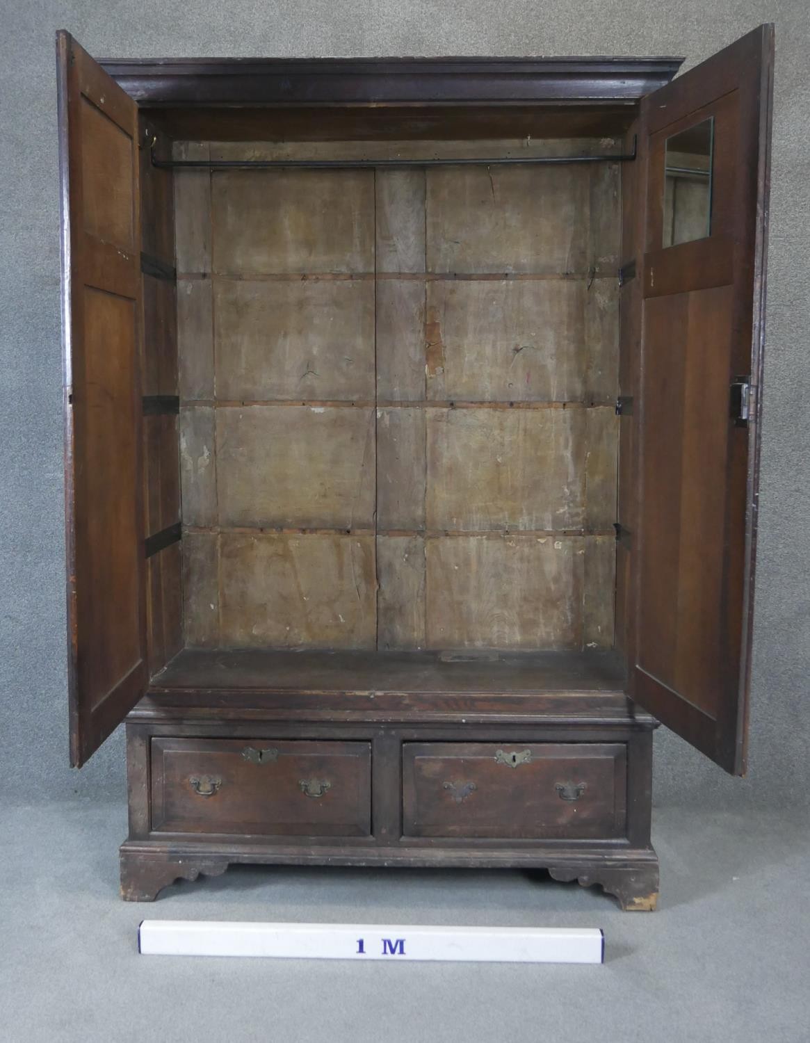 A Georgian country oak press cupboard with fielded panel doors above base doors on bracket feet. - Image 3 of 4