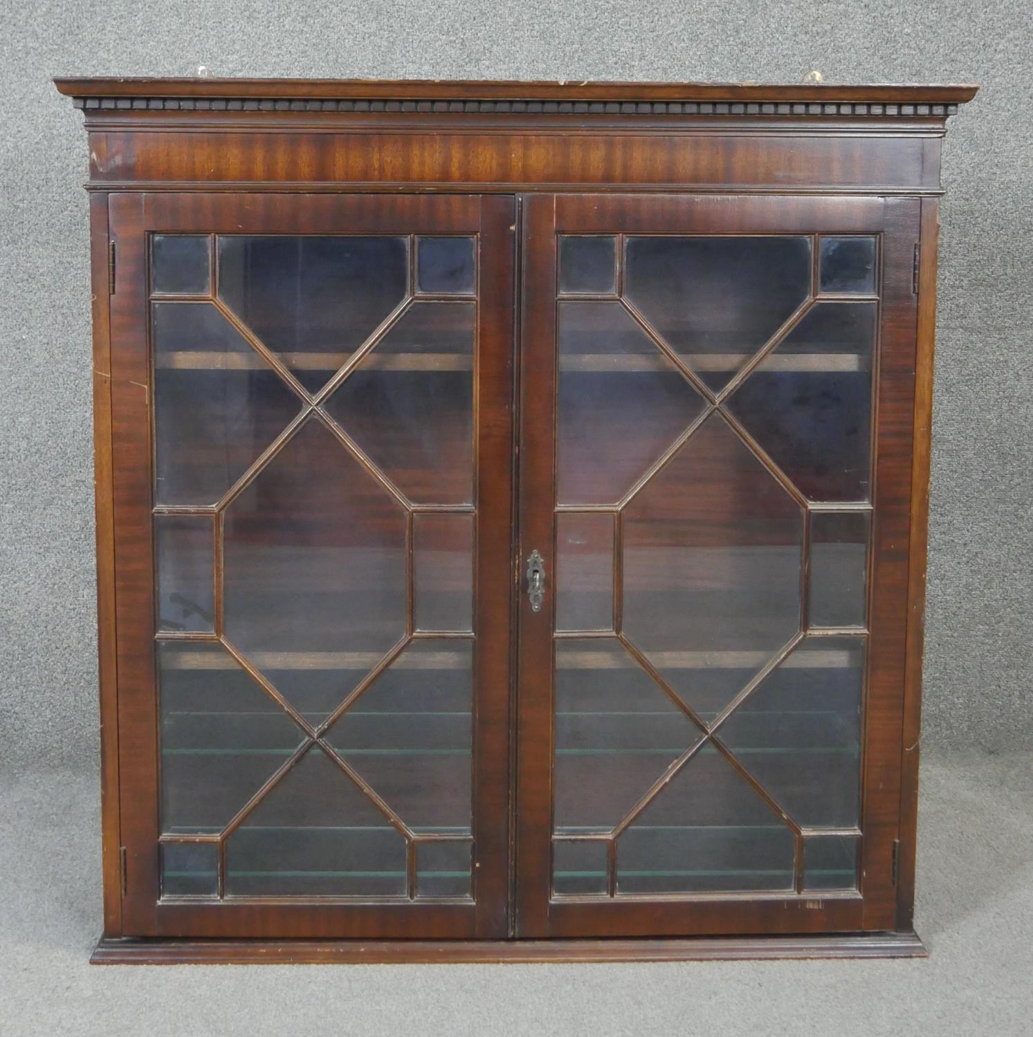 A Georgian style mahogany bookcase section with astragal glazed doors enclosing shelves. H93 W93