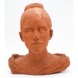 A sculpted terracotta bust of a female figure in evening dress. Monogrammed. H.38cm