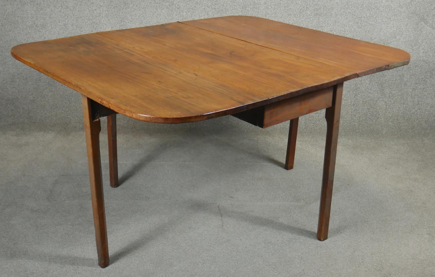 A Georgian mahogany drop flap dining table with gate leg action on square section supports. H.72 L. - Image 2 of 6