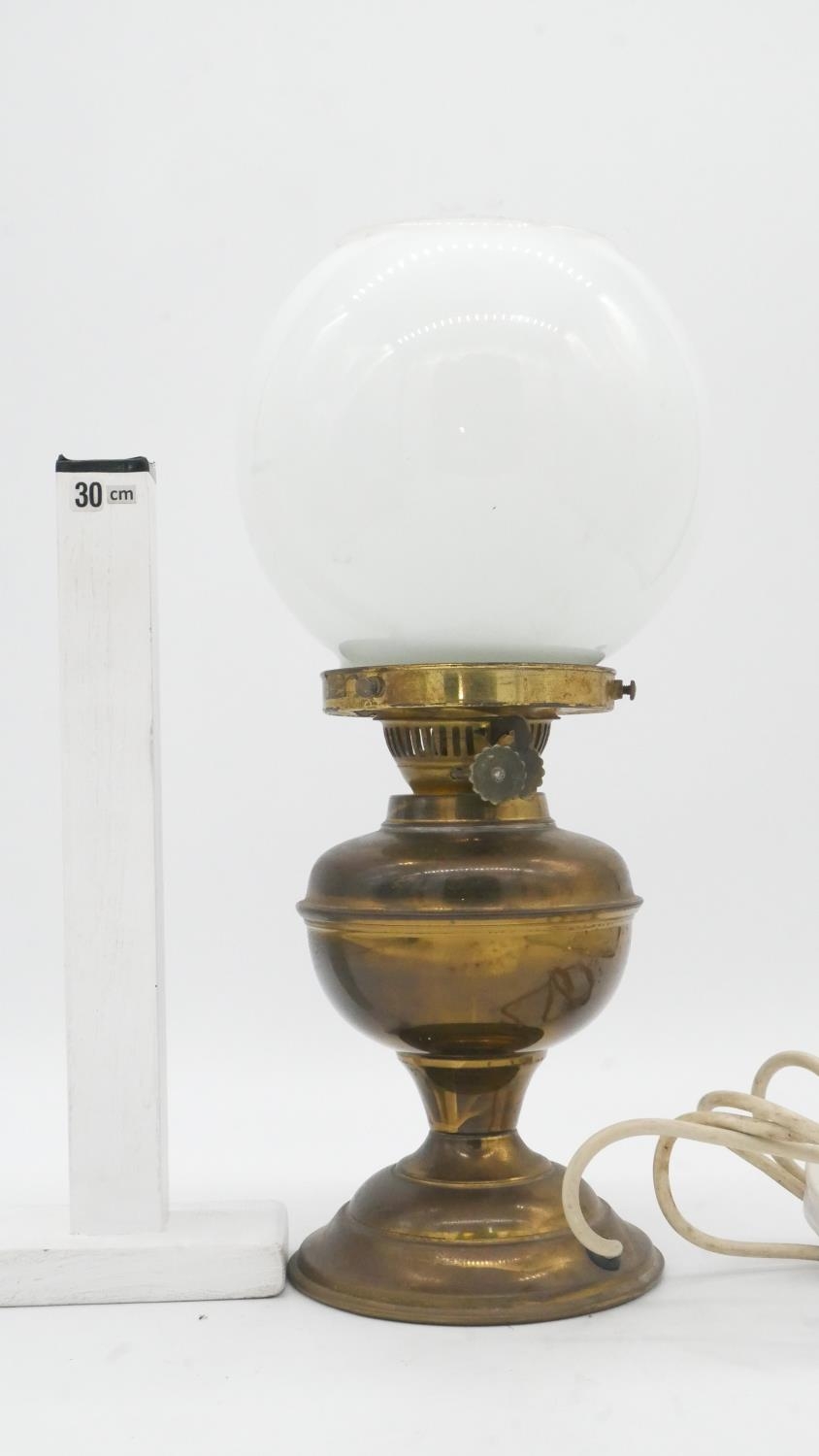 A vintage brass oil lamp with milk glass globe shade converted to electricity. H.38cm - Image 4 of 4
