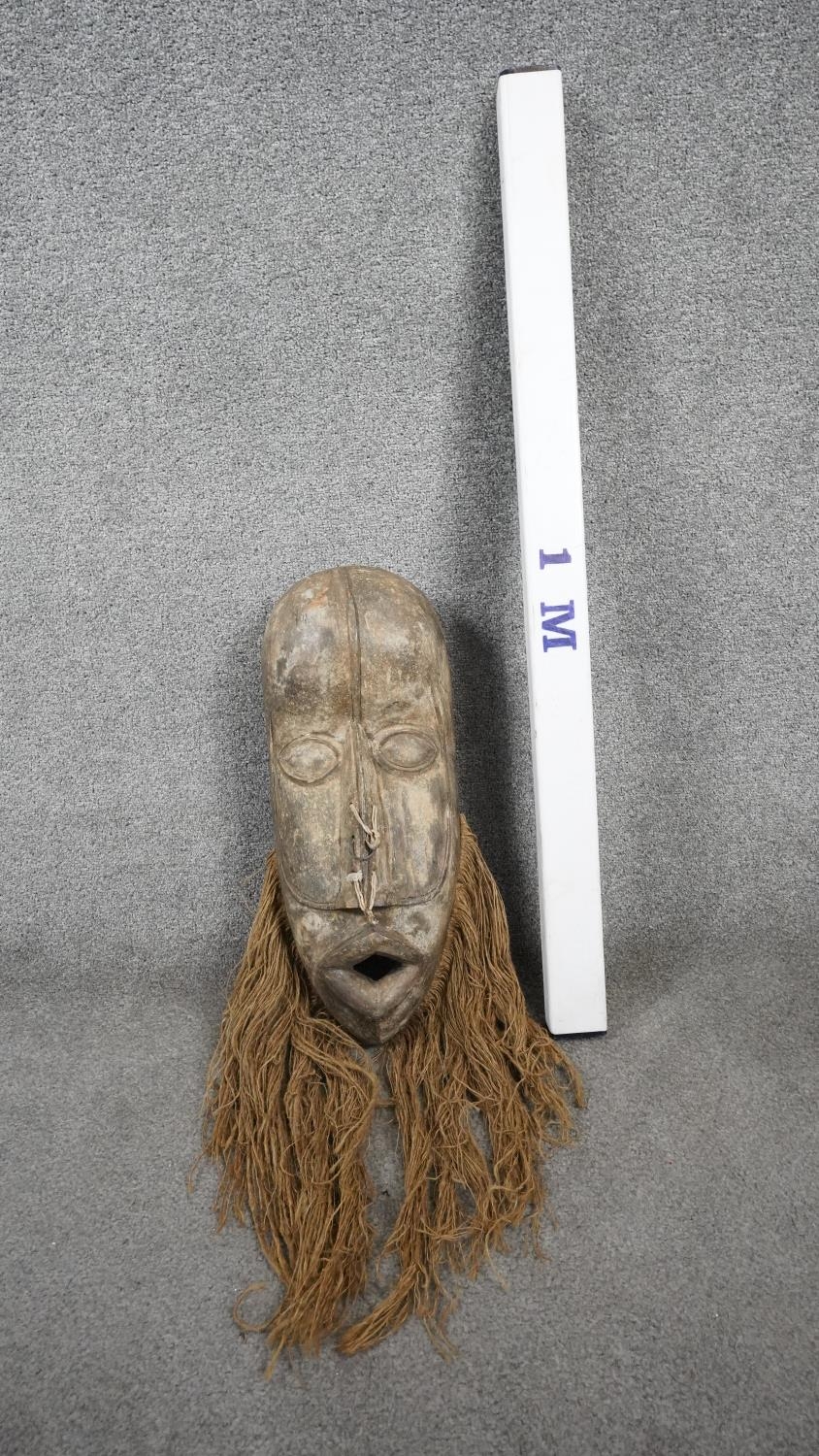 A vintage Republic of Congo carved wooden tribal mask with straw fibre beard and cowrie shell - Image 6 of 7