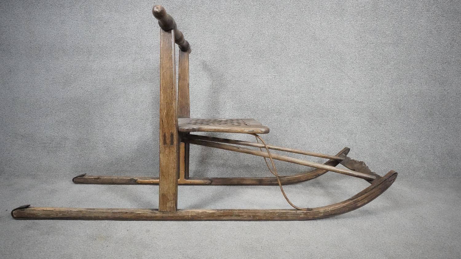 A vintage teak sled with slatted seat on metal faced runners. H.68 L.152cm - Image 3 of 4