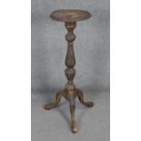 A Georgian style carved mahogany torchere on tripod cabriole supports. H92cm