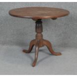 A Georgian oak tilt top occasional table on tripod cabriole supports. H50 D60cm