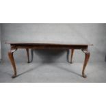 A mid century burr walnut Queen Anne style dining table with extra leaf. H.76 W.233 D.107cm