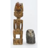 A carved wooden tribal figure along with a cast silver plated eagles head, a double dragon stamp