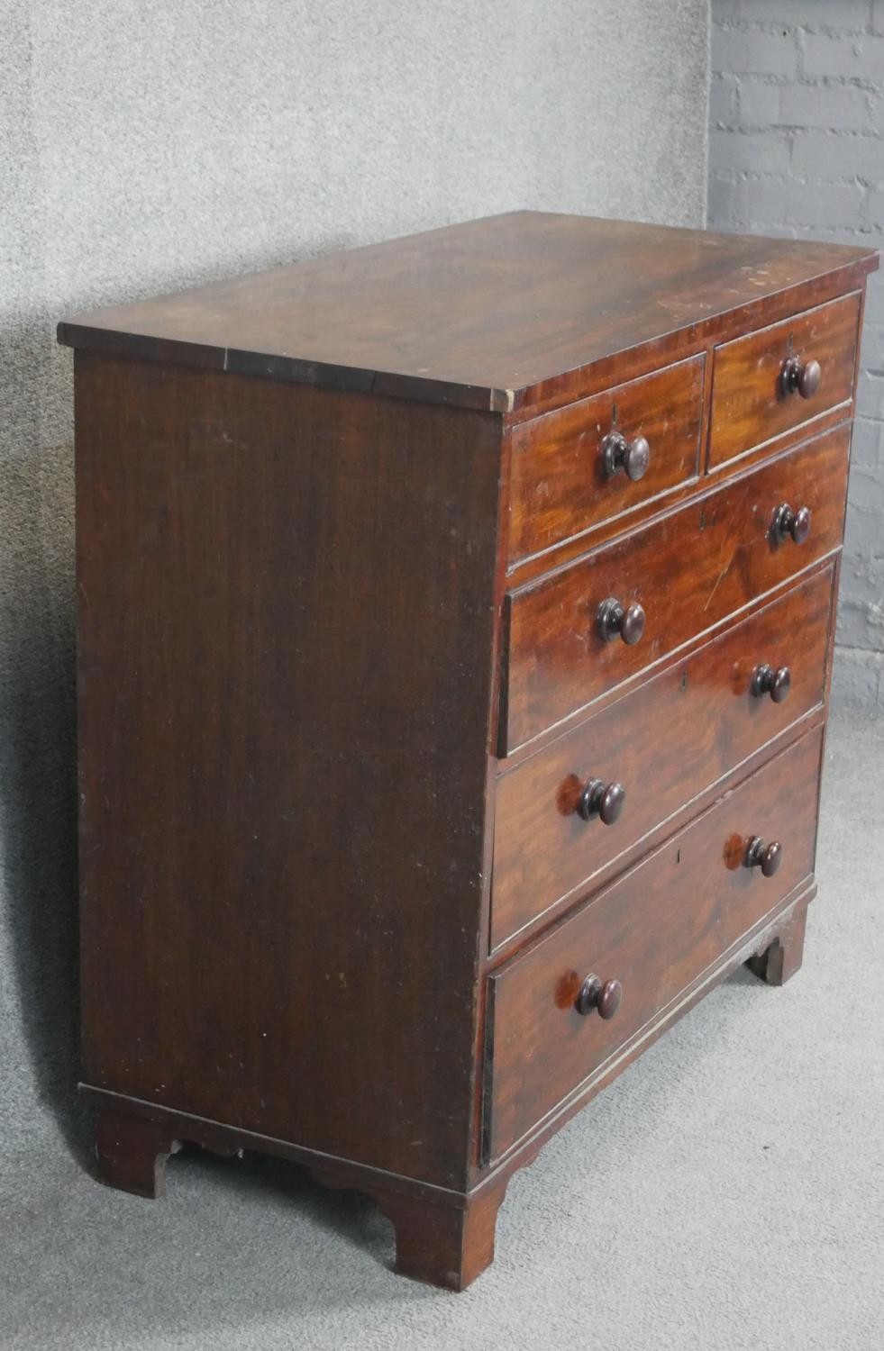 A 19th century mahogany chest with turned knob handles on shaped bracket feet. H97 W103 D50 - Image 3 of 3