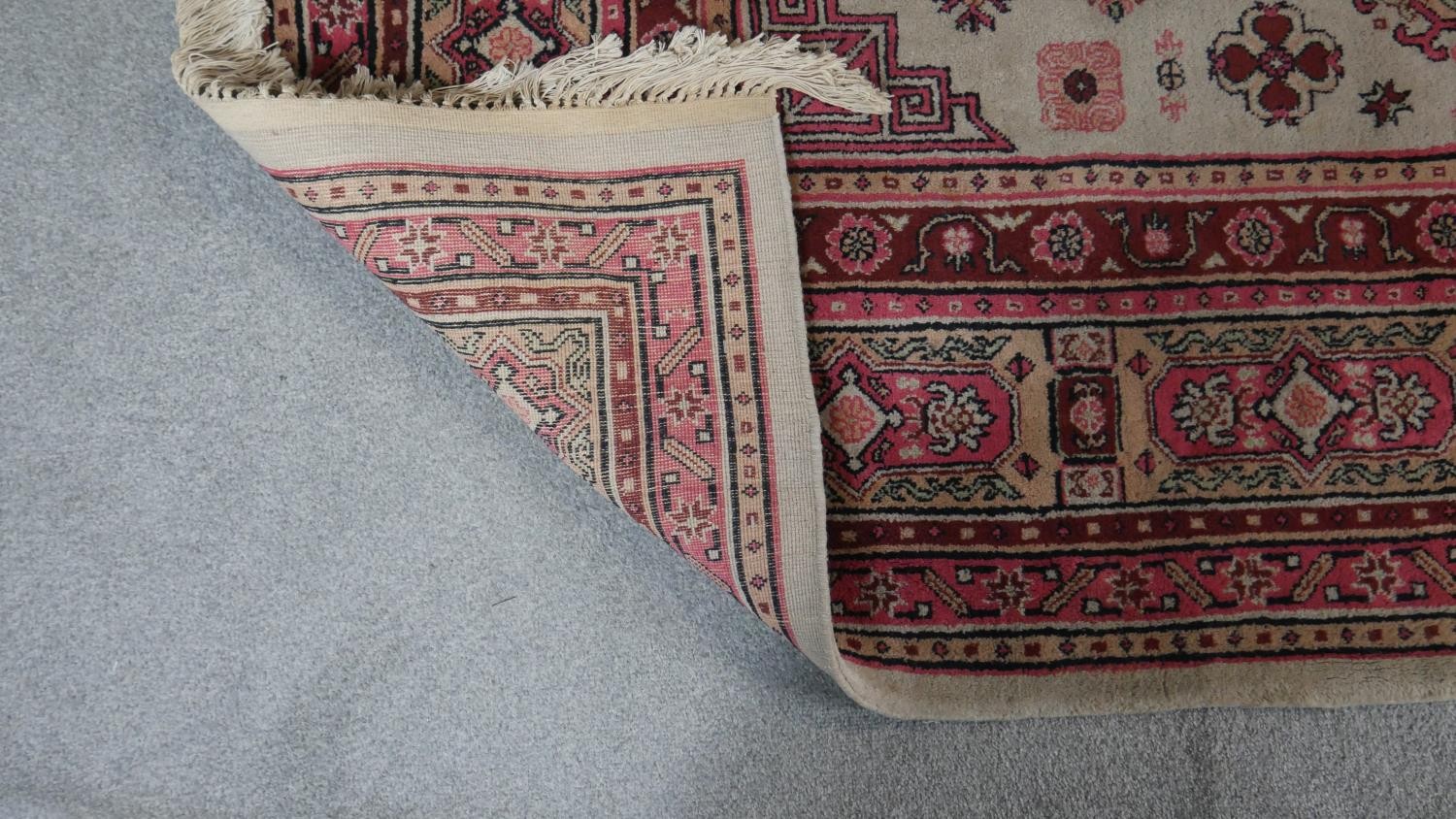 A Samarkand carpet with floral medallions on a beige ground. L.295 W.202cm - Image 3 of 4