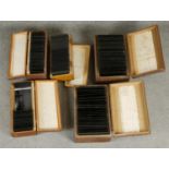Five wooden boxes of Victorian glass projector slides. Each box with a hand written description of