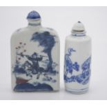 Two Chinese hand painted blue and white porcelain snuff bottles with blue glazed stoppers. One