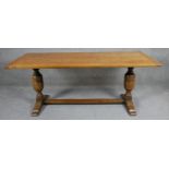 A mid century oak Jacobean style refectory dining table with planked and cleated top on baluster
