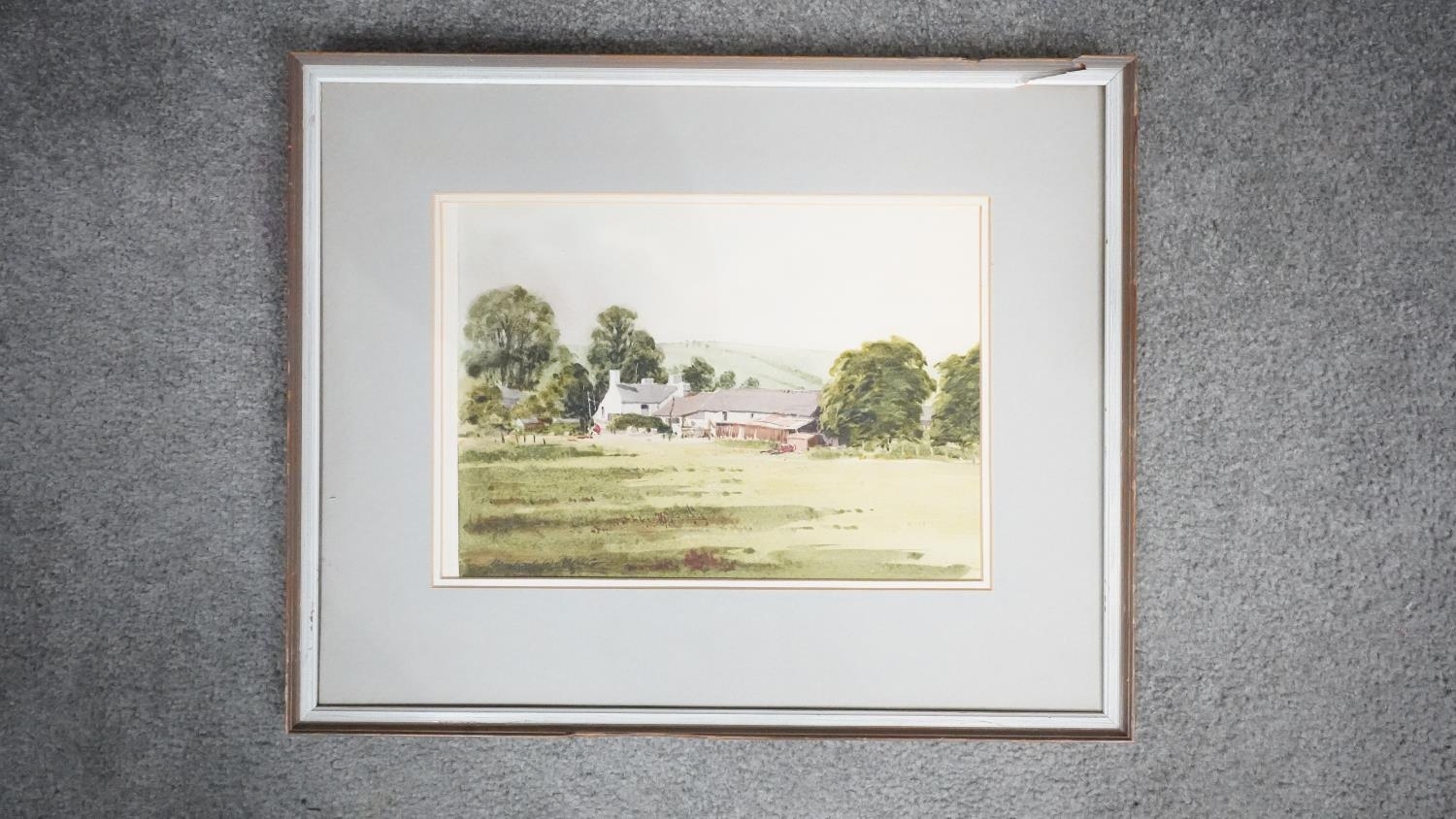 Michael W King - A framed watercolour on paper of a countryside landscape with cottage. Signed by