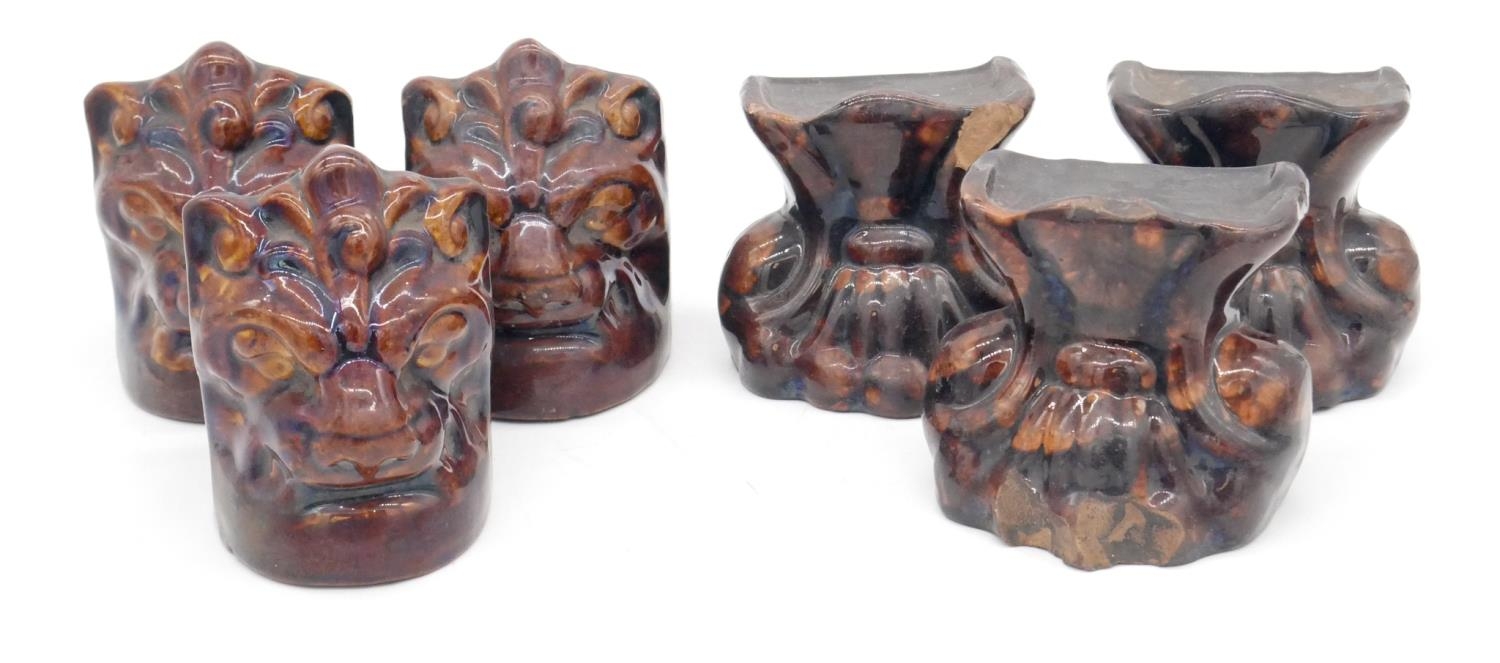 Two sets of three treacle glaze ceramic early Victorian shash windows stops. Three as lion heads and