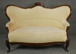 A 19th century mahogany sofa in carved and shaped frame on cabriole supports. H.100 W.156 D.70cm