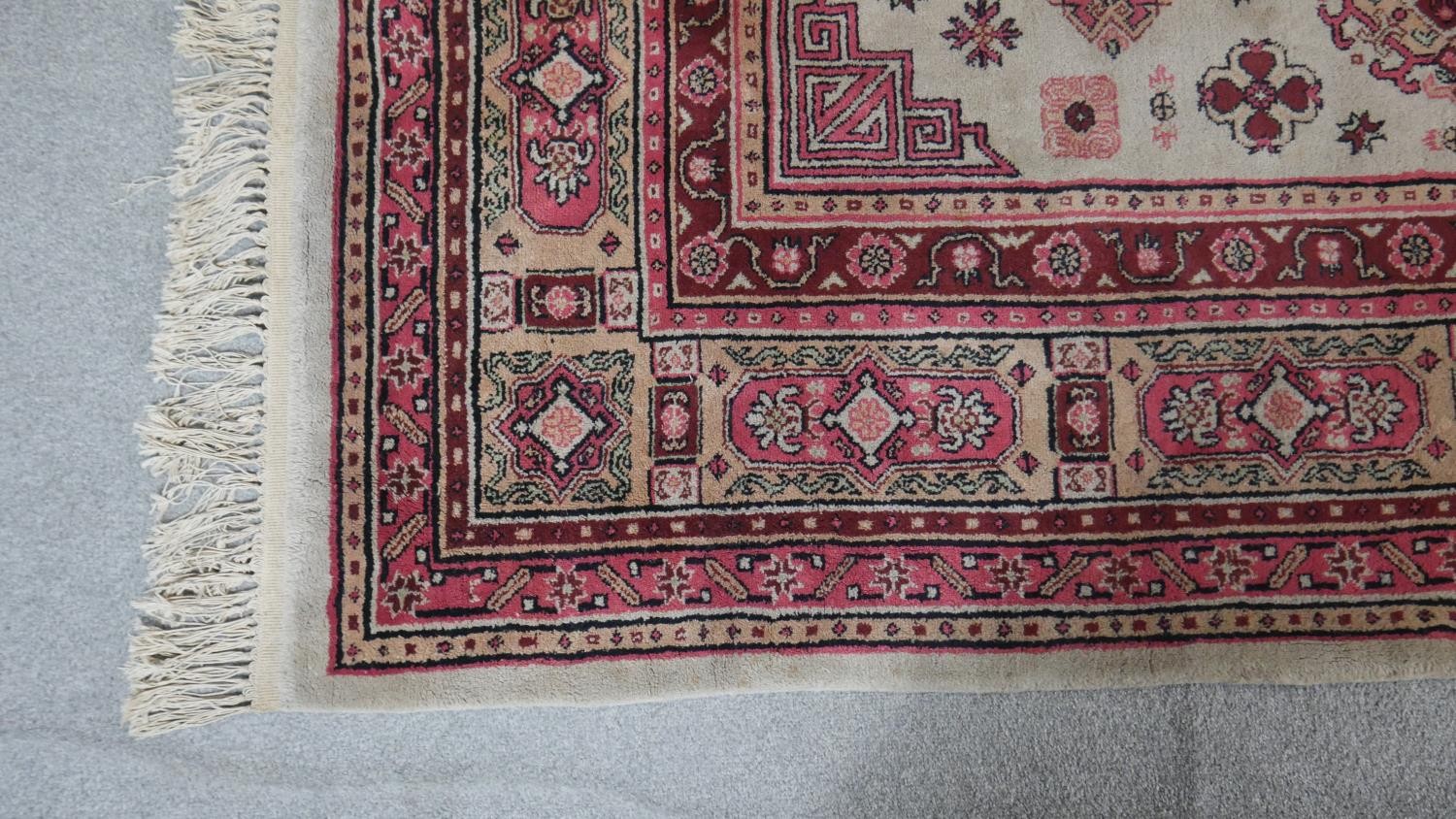 A Samarkand carpet with floral medallions on a beige ground. L.295 W.202cm - Image 2 of 4