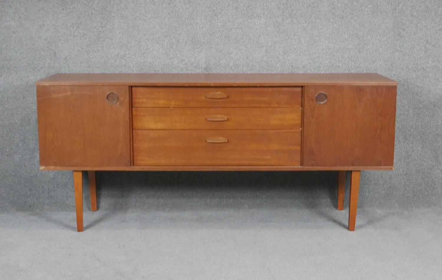 A vintage teak Avalon sideboard with cupboards and drawers on square tapering splay supports. H71
