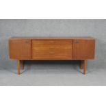 A vintage teak Avalon sideboard with cupboards and drawers on square tapering splay supports. H71