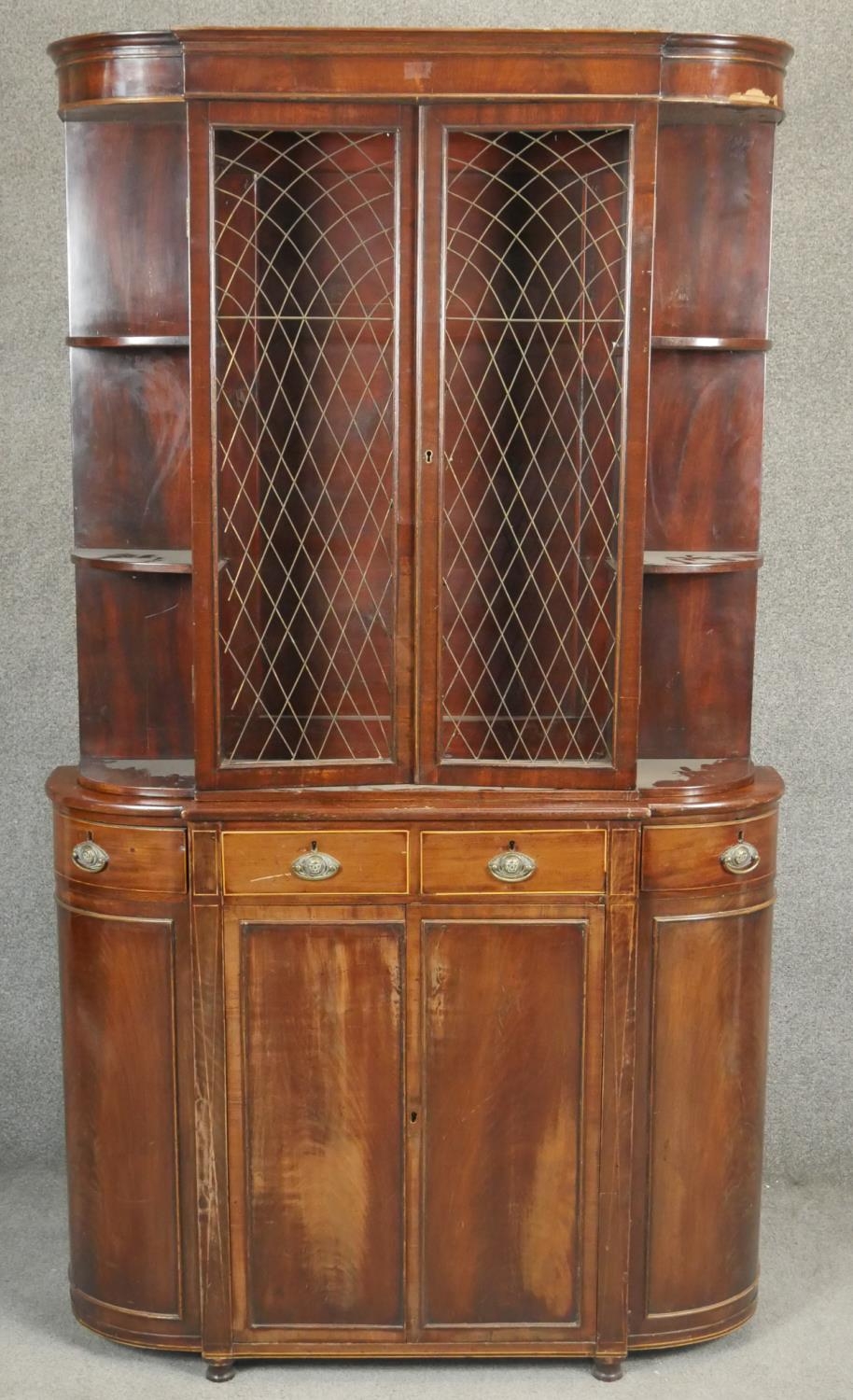 A 19th century style mahogany two section library bookcase of bowed outline. H.183 W.100 D.26cm